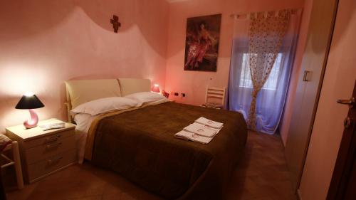 a bedroom with a bed with two towels on it at Heart Of Sicily in Mistretta