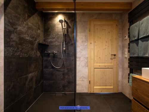 a shower with a glass door in a bathroom at Ferienhäuser Seiffen in Seiffen