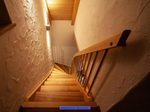 a hallway with a wooden staircase with a light on it at Ferienhäuser Seiffen in Seiffen