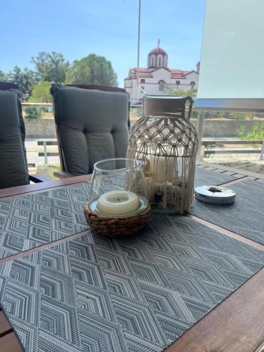 a table with a basket and a vase on a table at Nea Peramos Apartment SeaFront in Néa Péramos