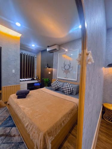 a bedroom with a large bed in a room at MIS HOSTEL Cần Thơ in Can Tho