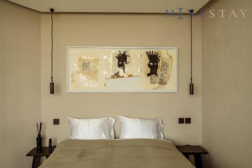 a bedroom with a bed with a picture on the wall at Sky Gardens, Park Avenue, DIFC - Mint Stay in Dubai