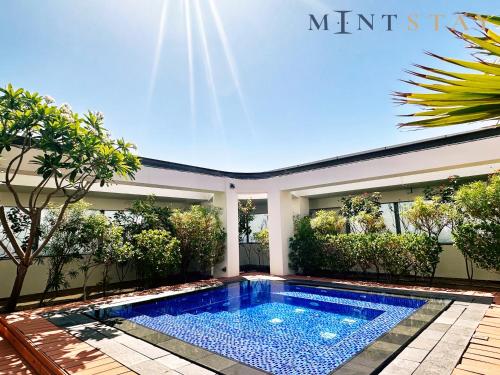 a swimming pool in the backyard of a house at Sky Gardens, Park Avenue, DIFC - Mint Stay in Dubai