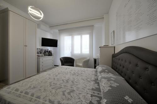 a bedroom with a bed and a dresser and a television at WAST-HOST by MICHELANGELO in Vasto