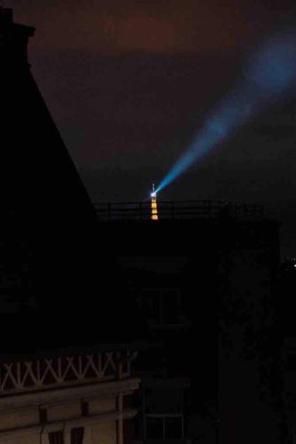 a light on top of a building at night at Cosy apartment in Paris area in Suresnes