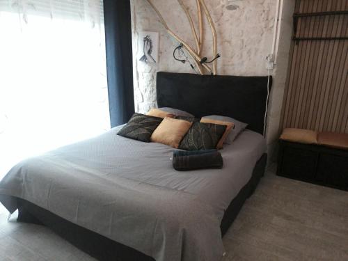 a bedroom with a large bed with pillows on it at A 2 pas d AZAY in Neuil