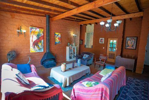 a living room with two couches and a stove at Kokopelli farm in Magaliesburg