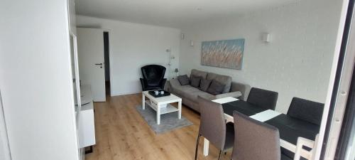 a living room with a couch and a table at Bungalow 2243 in Tossens in Butjadingen