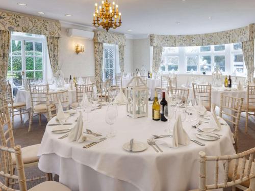 a dining room with a table with white table cloth at Sunday Box Hill Burford Bridge Hotel in Dorking