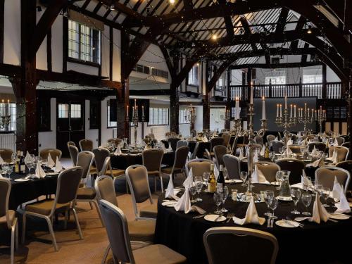 a banquet hall with tables and chairs and tablesearcher at Sunday Box Hill Burford Bridge Hotel in Dorking