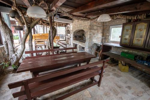 a wooden bench in a room with a piano at Villa Goga in Martinšćica