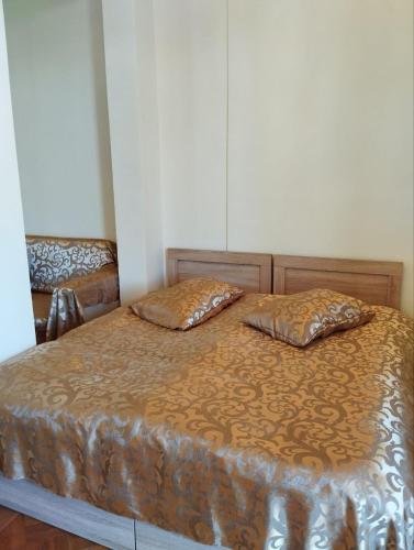 a bedroom with a bed with two pillows on it at Barateli in Kʼutʼaisi