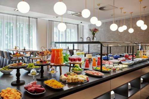 a buffet line with many different types of food at NH Berlin Kurfürstendamm in Berlin