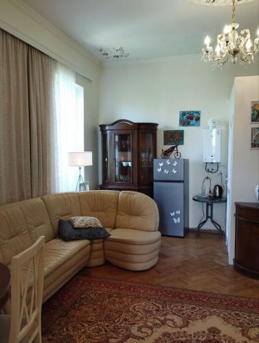 a living room with a couch and a refrigerator at Barateli in Kʼutʼaisi