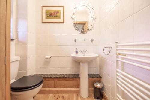 a bathroom with a toilet and a sink at 5 Toller Close, Orford in Orford