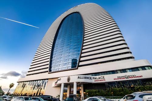 a tall building with cars parked in front of it at Annabelle Studio in Batumi