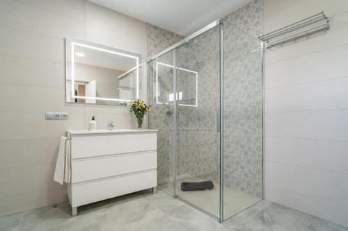 a bathroom with a glass shower and a sink at Casa rural Villa Gordito in La Lantejuela