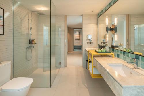 a bathroom with a toilet and a sink and a shower at Holiday Inn Pattaya by IHG in Pattaya Central
