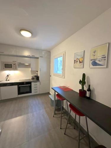 une cuisine avec une table et des chaises dans une pièce dans l'établissement Appartement Grand Veneur CityCosy, à Paris