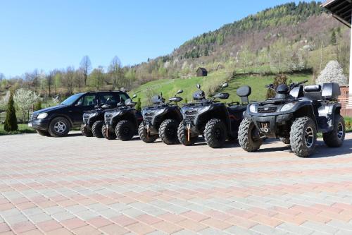 a row of four atvs and a jeep parked at CASA LAURENTIU in Borşa