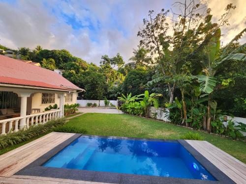 an image of a backyard with a swimming pool and a house at Kaz Memel in Beau Vallon