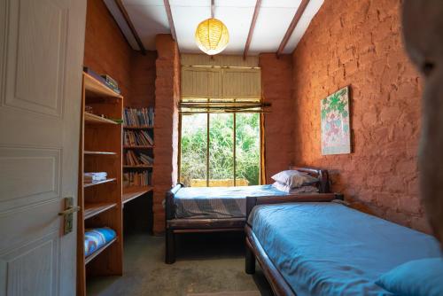 a bedroom with two beds and a window at Kokopelli farm in Magaliesburg