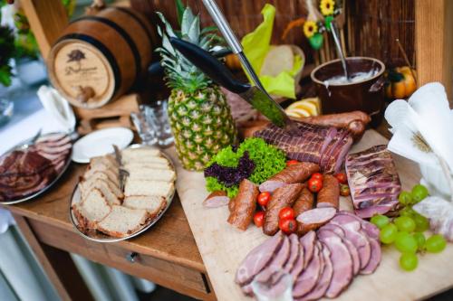 a table topped with different types of meat and vegetables at Centrum Restauracyjno-Hotelowe Florres in Pawłowiczki
