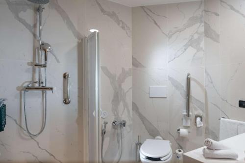 a bathroom with a shower and a toilet at Hilton Garden Inn Milan Malpensa in Somma Lombardo