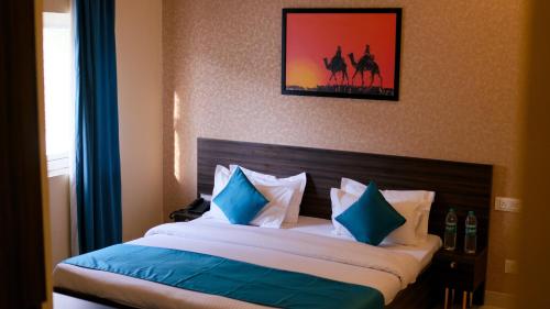 a bedroom with a bed with blue and white pillows at Bodhi Retreat in Pushkar