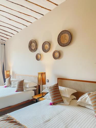 Postel nebo postele na pokoji v ubytování Movenpick Resort Lamantin Saly