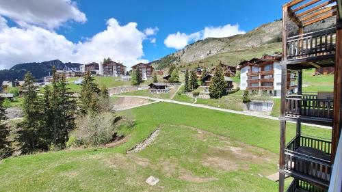 an aerial view of a resort with a green field at Haus Bella Vista in Riederalp