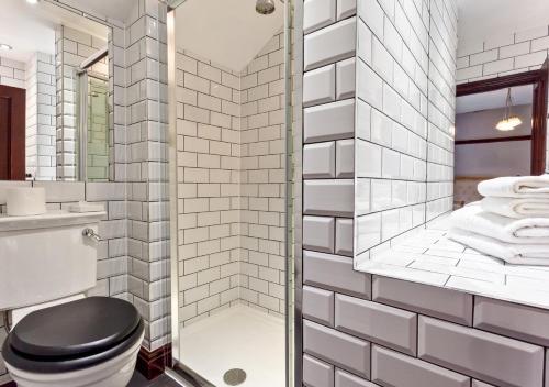 a bathroom with a toilet and a glass shower at Broadoaks Boutique Country House in Windermere