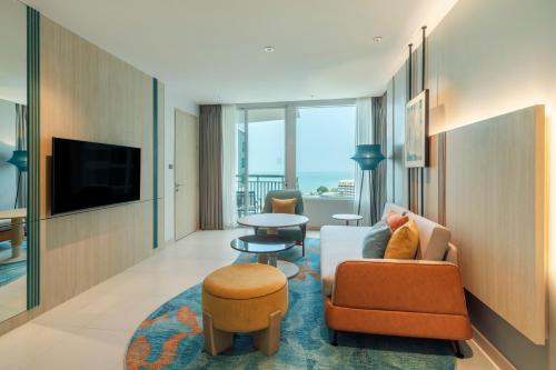a living room with a couch and a table at Holiday Inn Pattaya by IHG in Pattaya Central