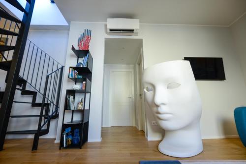 a living room with a white head next to a staircase at Attico Centro con terrazza e jacuzzi e parcheggio privati in Genova