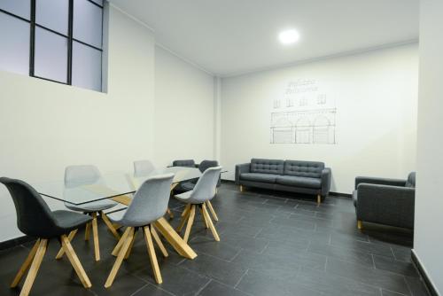 a conference room with a glass table and chairs at Attico Centro con terrazza e jacuzzi e parcheggio privati in Genova