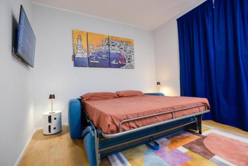 a bedroom with a bed in a room with blue curtains at Attico Centro con terrazza e jacuzzi e parcheggio privati in Genova