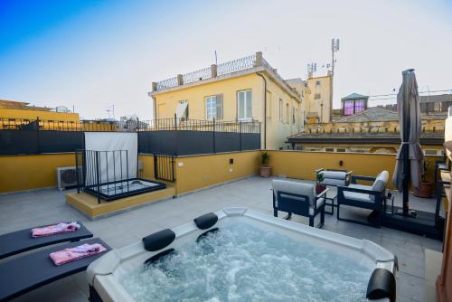 a hot tub on a patio on a roof at Attico Centro con terrazza e jacuzzi e parcheggio privati in Genova