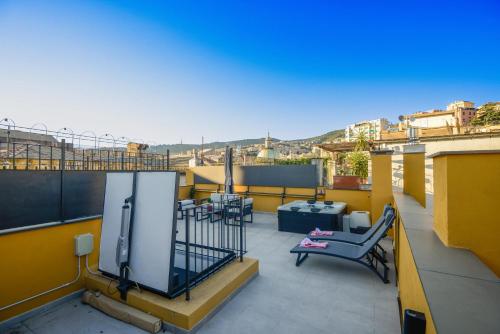 a balcony with a flat screen tv on a building at Attico Centro con terrazza e jacuzzi e parcheggio privati in Genova