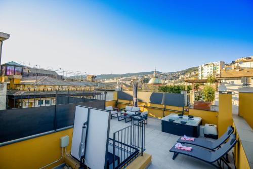 a balcony with a flat screen tv on top of a building at Attico Centro con terrazza e jacuzzi e parcheggio privati in Genova