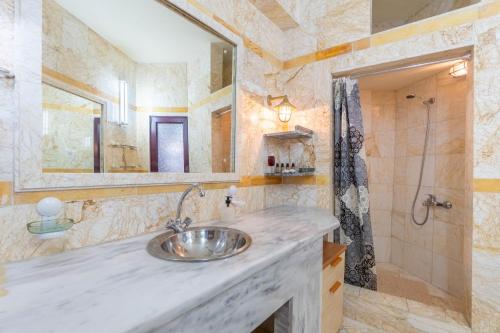 a bathroom with a sink and a shower at Paco's Superior Double Villa 15 in Oziás