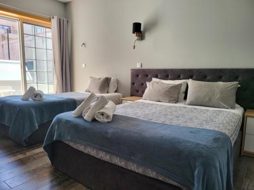 two beds sitting next to each other in a bedroom at Leao de Ouro in Matosinhos