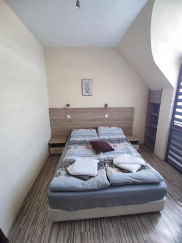 a bedroom with a bed with pillows on it at Sapareva Apartments in Sapareva Banya