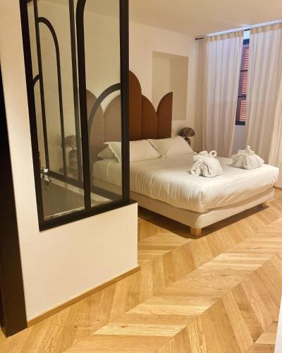 a bedroom with a bed and a mirror at Résidence Côté Sud in LʼÎle-Rousse