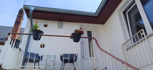 a porch with chairs and plants on a house at Schnick Schnack in Kröv