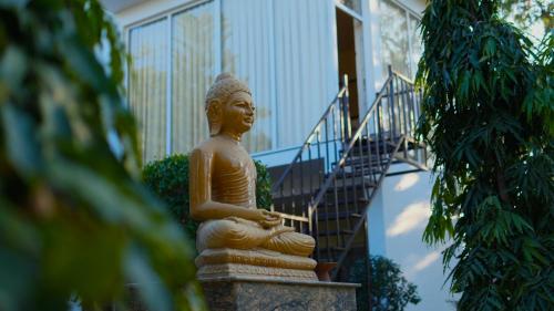 a statue sitting in front of a building at Bodhi Retreat in Pushkar