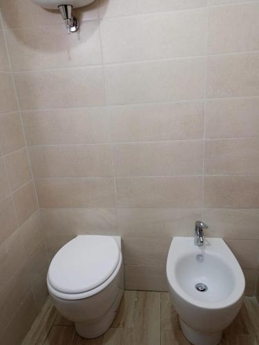 a bathroom with a toilet and a sink at B&B Leonida in Tropea