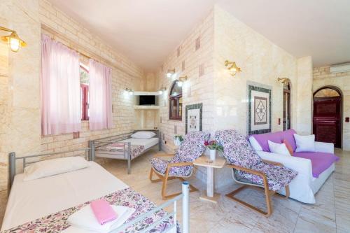 a living room with a couch and a table at Paco's Resort Family Villa 12 in Oziás