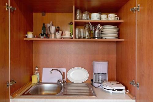 a kitchen with a sink and a counter top at Areti Orfeas Studios in Vasilikos