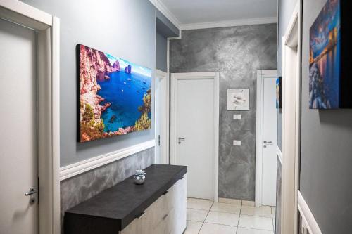 a bathroom with a large painting on the wall at Mare Fuori casa vacanze in Castellammare di Stabia