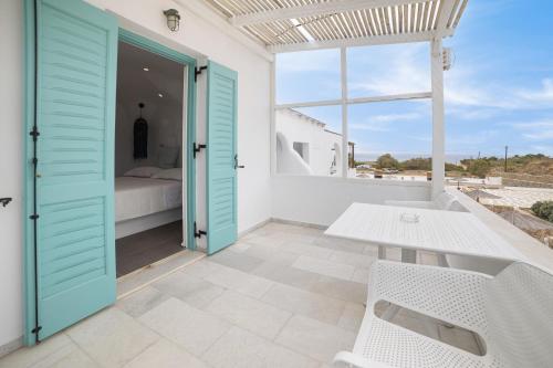 a room with a table and a view of a bedroom at Naxos Cave Suites in Stelida